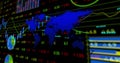 Displaying blue world map silhouette overlaying market data on dashboard, with colored line graphs Royalty Free Stock Photo