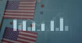 Displaying flat lay on grid surface, featuring American flags, star cutouts, bar graph overlay Royalty Free Stock Photo