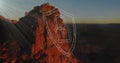 Displaying red cliff glowing at desert canyon dusk, with shield showing camera icon and code lines Royalty Free Stock Photo