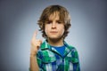 Displeased angry boy with threatens finger isolated on gray background Royalty Free Stock Photo