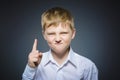 Displeased angry boy with threatens finger isolated on gray background Royalty Free Stock Photo