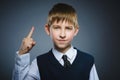 Displeased angry boy with threatens finger isolated on gray background Royalty Free Stock Photo