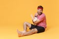 Displeased bearded fitness sporty guy sportsman in headband t-shirt in home gym isolated on yellow background. Workout