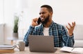 Displeased Black Guy Talking Having Quarrel By Phone At Workplace