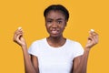 Displeased Black Woman Holding Earbuds Earphones Standing In Studio