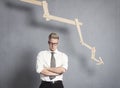 Displeased businessman in front of graph with negative trend. Royalty Free Stock Photo