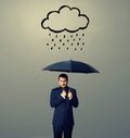 Displeased businessman with umbrella