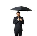 Displeased businessman with umbrella