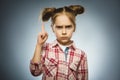 Displeased and contemptuous girl with threatens finger on gray background Royalty Free Stock Photo