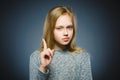 Displeased and contemptuous girl with threatens finger on gray background Royalty Free Stock Photo