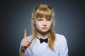 Displeased and contemptuous girl with threatens finger on gray background Royalty Free Stock Photo