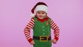 Displeased girl in Christmas costume gesturing hands with displeasure, blaming scolding for failure Royalty Free Stock Photo