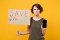 Displeased protesting woman hold protest broadsheet placard mobile phone with blank empty screen isolated on yellow