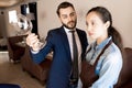 Displeased restaurateur showing dirty wineglass to waitress