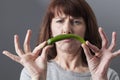Displeased 50s woman disgusted at the idea of eating chili or spice ingredients Royalty Free Stock Photo
