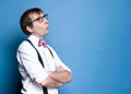 Displeased sly man with crossed arms in pink shirt with rolled up sleeves, bow tie, black suspender and glasses looking away