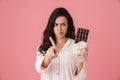 Displeased woman wagging her finger while posing with chocolate Royalty Free Stock Photo
