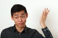 Displeased young Asian man gesturing with his hand Royalty Free Stock Photo