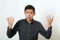 Displeased young Asian man gesturing with two hands Royalty Free Stock Photo