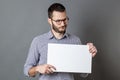 Displeased young businessman claiming on protest sign