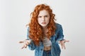 Displeased young foxy girl stretching to camera looking brutally gesturing over white background. Royalty Free Stock Photo