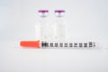 Dispoable syringe and Purple cap of medicine injection vial Royalty Free Stock Photo