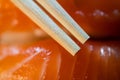 Disposable bamboo chopsticks and salmon sushi in background macro