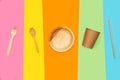 Disposable bamboo kitchen utensils on a multicolored background
