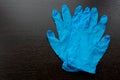 Disposable blue medical gloves on a black