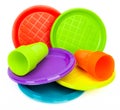 Disposable bright plastic plates and cups on white Royalty Free Stock Photo