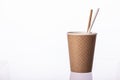 Disposable brown paper cup waffle texture with straws, isolated white background