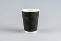 Disposable, cardboard black Cup isolated on a white background.