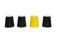 Disposable cardboard coffee cups in yellow and black on a white background Royalty Free Stock Photo