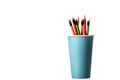 Bunch of multi colored wooden pencils with rubber eraser in blue paper cup Royalty Free Stock Photo