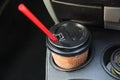 Disposable coffee cup inside car cup holder. Royalty Free Stock Photo