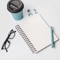 disposable coffee cup pen eyeglasses spiral notepad thumbtack pins white background. High quality photo Royalty Free Stock Photo