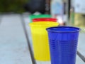 Disposable colorful cups with beverages.
