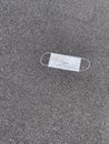 Disposable Covid-19 mask on the pavement