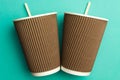 Disposable cups for hot drinks on a turquoise backgrounds. Paper cups Royalty Free Stock Photo