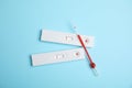 Disposable express hepatitis test kit on light blue background, flat lay Royalty Free Stock Photo