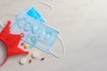 Disposable face mask and pills on light background Royalty Free Stock Photo