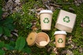 Disposable food packaging with a recycling sign in a forest clearing. Zero waste concept. Royalty Free Stock Photo