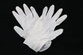 Pair of two medical white rubber gloves on black background.