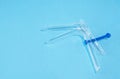 Disposable gynecological dilator for vaginal examination on blue background. Gynecological examination. Flat lay