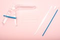 Disposable gynecological examination kit on a pink background. Gynecological examination set. The view from the top