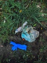 Disposable medical gloves on ground with single use plastic trash. How to dispose used medical gloves right after coronavirus pand Royalty Free Stock Photo