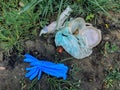 Disposable medical gloves on ground with single use plastic trash. How to dispose used medical gloves right after coronavirus Royalty Free Stock Photo