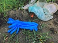 Disposable medical gloves on ground with single use plastic trash. How to dispose used medical gloves right after coronavirus Royalty Free Stock Photo