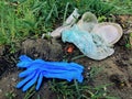 Disposable medical gloves on ground with single use plastic trash. How to dispose used medical gloves right after coronavirus Royalty Free Stock Photo