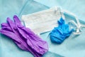 Disposable medical mask and latex gloves on a blue non-woven material. Personal Protection Concept Royalty Free Stock Photo